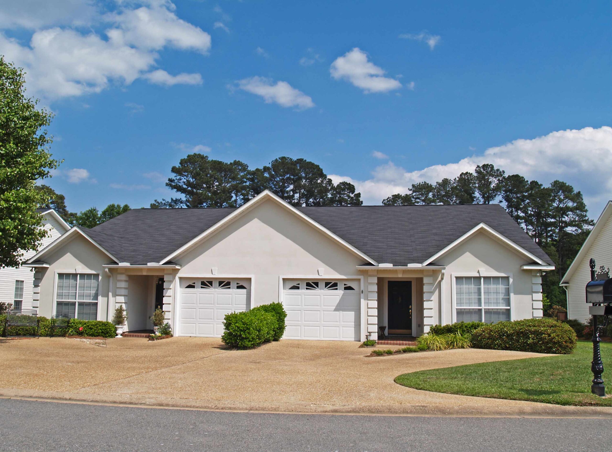 A front exterior of a block and stucco Florida duplex.